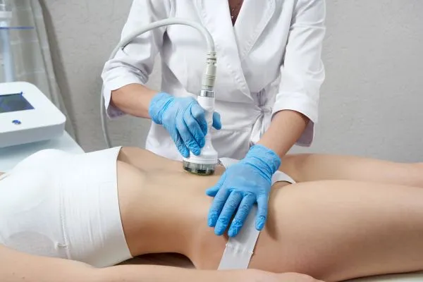Lost the Weight but Not the Loose Skin? 2 woman having HIFU treatment on her stomach to combat loose skin Chipping Norton following weight loss